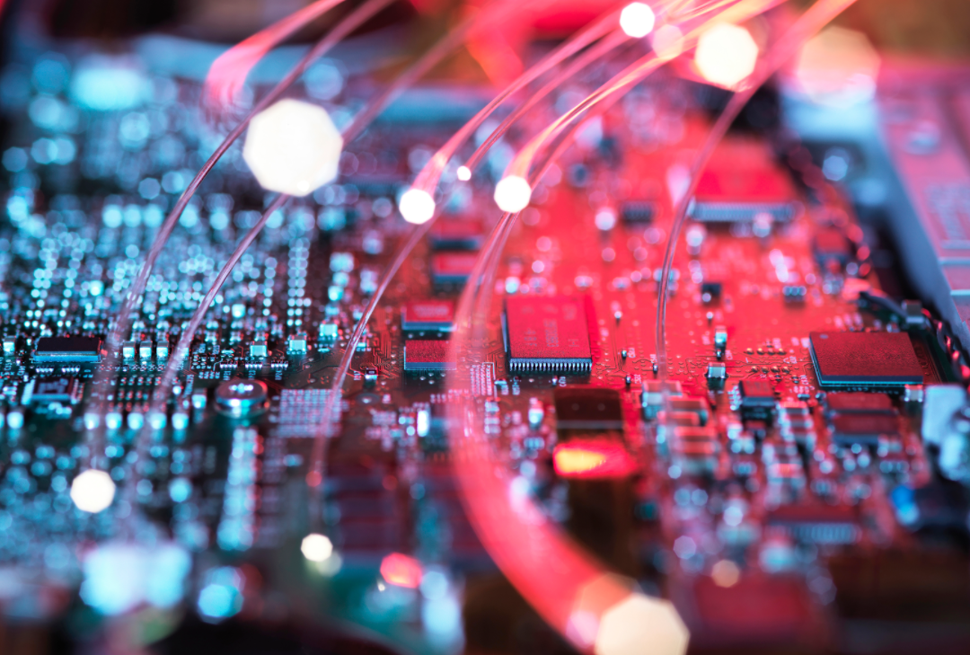 A photo of a circuit board with fiber optic strands - Courtesy Microsoft Designer